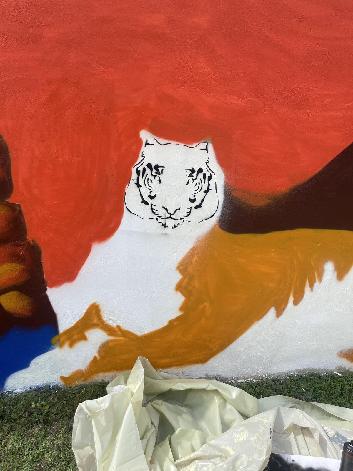 First spray painted lines of the tiger on the gable wall